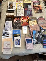 Overview of assorted sheet music and songbooks laid on bed