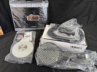 Group photo of boxed Leivi shower set, packaged Gorilla Grip mat and Oxo drain cover