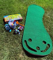 Overall lot showing putting green, boxed Frisbee Field Goal, beach toys and water balls