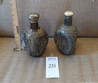 Front view of both decanters with stoppers and ruler for scale