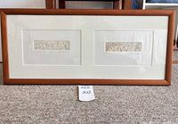 Front view of framed artwork showing two drawings under mat within wood frame