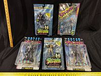 Front view of five Spawn action figures in packaging