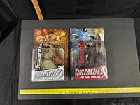 Front view of both sealed Unleashed figures with ruler for scale