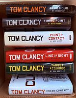 Stack of six Tom Clancy hardcover novels with dust jackets