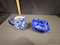 pitcher and lidded box side by side showing form and pattern