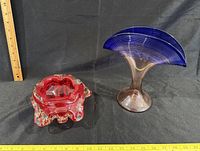 Ashtray and vase side by side with rulers for scale