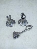 Two short grapevine candlesticks and matching snuffer displayed