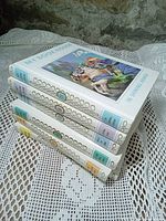 Stack of four My Book House volumes showing decorative spines