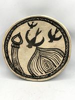 Front of charger showing swallow, dome and spire motif