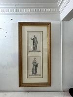 Full view of framed engravings on wall