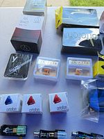 Close-up of cartridge and stylus boxes plus two headshells