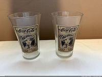Front view of both Coca-Cola tumblers showing decals and overall shape