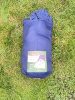 Sleeping bag in stuff sack on grass