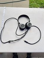 Full view of Grado SR325 headphones with cable and 3.5 mm plug on table