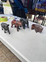 All four wooden animal figurines on tabletop