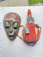 Overall view of wall mask and canteen with scale