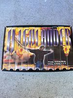 Top view of 10 VHS tapes in slipcase spelling HIGHLANDER