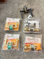 Overview of all five handle/knob sets including three blister lever sets, one blister knob set, one loose black lever set