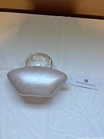 Clutch on surface with tag attached