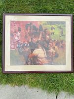 Full view of framed sports print laying on grass