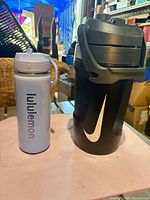 Front view of both bottles showing brands, colors and overall design