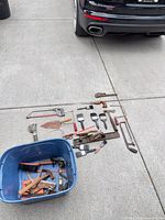 All tools laid out beside blue tub for overview