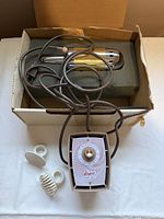 Overview showing chrome wand, control unit, cords, heads and original box