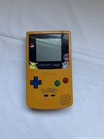 Front view of Pokémon yellow Game Boy Color showing decals and controls