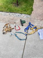 All items laid out: harness, two lanyards, tool pouch