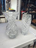 Both crystal vases full view on table showing shapes and patterns