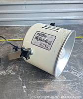 Side view of White Lightning 5000 showing logo plate and bracket