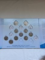 Open folder showing triangular layout with 15 coins, one empty slot