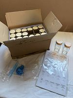 Box containing 24 glass spice jars with bamboo lids plus accessories laid out