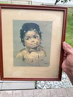 Full view of framed print held outdoors
