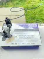 Player box with articulating mount placed on top, overall view of lot contents