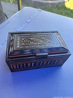 Angled view of closed carved wooden box top