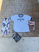 Entire lot laid out: fleece piece, T-shirt, foam finger, flag