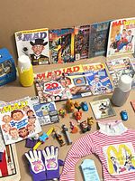 Group view showing MAD magazines, comics, thermoses, toys and clothing