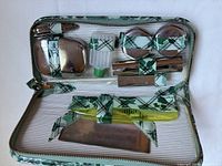 Open case showing all tools, containers, comb and mirror