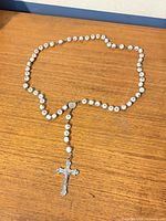 Full view of entire rosary laid out showing beads, centerpiece, and crucifix