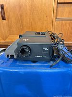 Front view of projector showing lens and tray mount