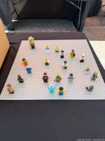 Top view showing all 20 minifigures on grey baseplate
