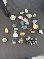 All stones laid out on black surface showing variety and size range