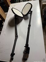 Two Elgato Key Light units showing front diffused panels and adjustable arms with desk clamps