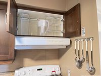 Cabinet view showing Brita pitcher centered among plastic containers