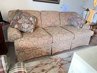 Front view of Brunetti floral tapestry sofa with two throw pillows