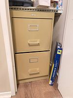 Full view of beige 2-drawer cabinet in closet