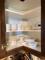 Two shelves showing ramekins and various Cornflower casseroles and bakers