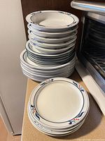 Stack of bowls and plates showing pattern and quantity