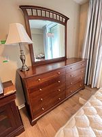 Front view of dresser with attached mirror showing overall style, drawer layout, hardware, finish